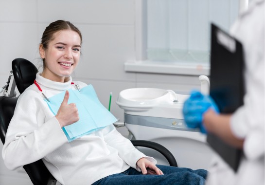 Happy young female at the dentist